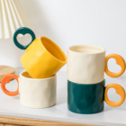 Ceramic cup with a heart - shaped handle